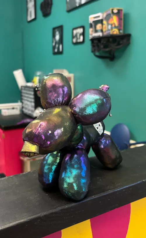 Full Tilt's resident support doggie, a plush pierced good-luck charm on the shop counter